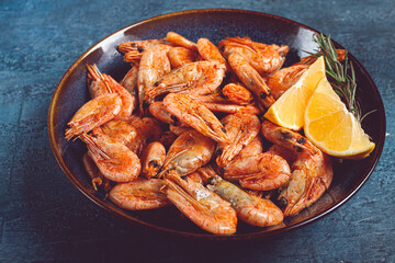 fried shrimp, with shell and head, unpeeled, size 70-90, on a blue background, homemade, no people,