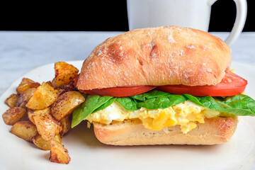 scramble  egg with  spinach and tomato  on a roll
