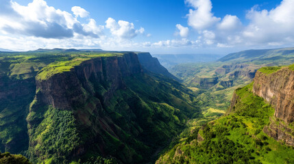 Naklejka premium A stunning view of the Simien Mountains in Ethiopia, with dramatic cliffs and valleys under a bright blue sky.
