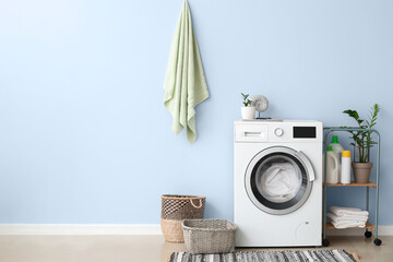 Interior of bathroom with modern washing machine