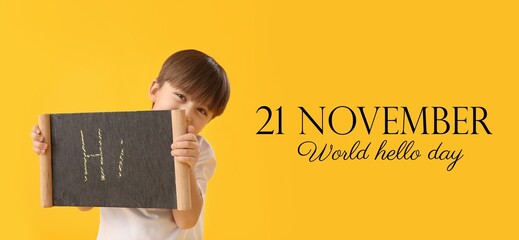 Banner for World Hello Day with little boy holding chalkboard on yellow background