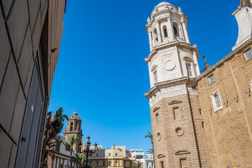 Fototapeta premium Bell towers of the Cathedral of La Santa Cruz of Cádiz and the Church of Santiago Apostle, SPAIN