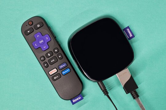Roku streaming media player remote control blue background Houston TX USA 05-01-2024.	