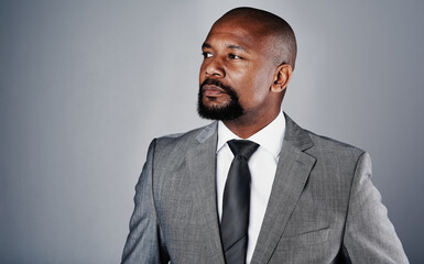 Studio, black man and serious with thinking for business, planning and brainstorming for court. Mockup space, case solution and lawyer with thoughts for justice, corporate firm and gray background
