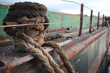 Rope knot old rusty abandoned ship in the sea