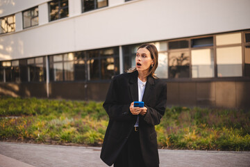 Business short hair woman wear jacket suit, standing outdoor near office, looking, waiting or...