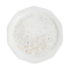 Appetizing milk oatmeal porridge served on plate for breakfast. Isolated over white background