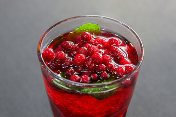 Berry cranberry tea with mint in a glass glass