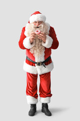 Santa Claus with tasty donut on white background