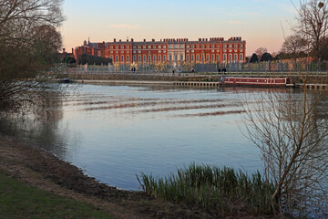 Fototapeta premium Georgian facade of Hampton Court Palace reflected in, and viewed from, the River Thames