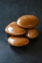 A group of brown pebbles sitting on top of a black surface