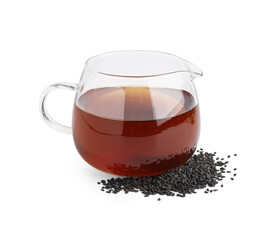 Glass jug of oil with sesame seeds on white background