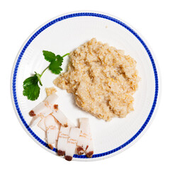 Simple homemade traditional Ukrainian dish - boiled oatmeal and salted bacon pork lard. Dish is decorated with sprig of parsley. Rustic lunch, traditional Eastern European food - porridge and bacon