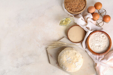 Fresh raw dough with wheat, eggs, bowls of flour and grains on white background