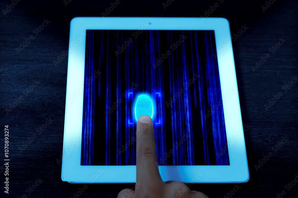 Aufkleber man using fingerprint scanner in tablet by touching it, closeup