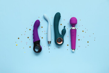 Different vibrators and confetti on blue background