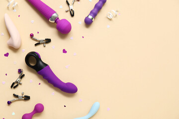 Different vibrators and nipple clamps on yellow background