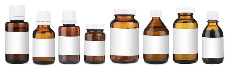 Many different glass bottles with labels isolated on white