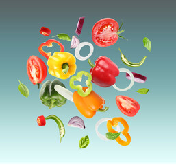 Many different fresh vegetables in air on color gradient background