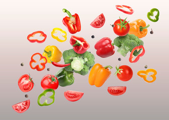 Many different fresh vegetables in air on color gradient background
