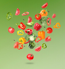 Many different fresh vegetables in air on green gradient background