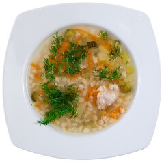 Appetizing rassolnik soup with sour pickles and pearl barley served in bowl. Isolated over white background