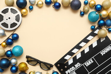Composition with film reel, 3D glasses, movie clapper and Christmas decorations on beige...