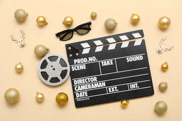 Composition with film reel, 3D glasses, movie clapper and Christmas decorations on beige...