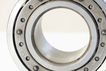 Metal ball bearing, on white background. Stainless steel roller. Spare parts. Macro photography