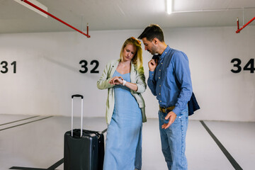 Couple searching for their car in an underground garage.