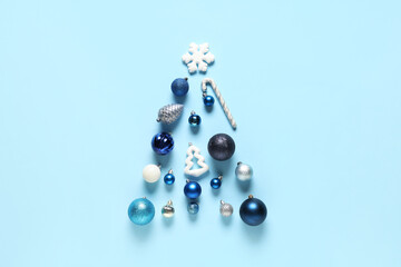 Christmas tree made of different decorations on blue background