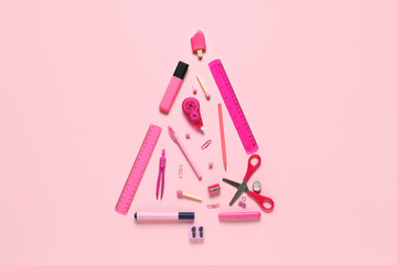 Christmas tree made of different stationery supplies on pink background