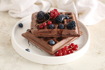 Plate of sweet chocolate Belgian waffles with fresh berries on white background