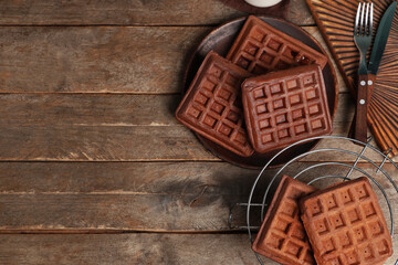 Stand and plate of sweet chocolate Belgian waffles on wooden background