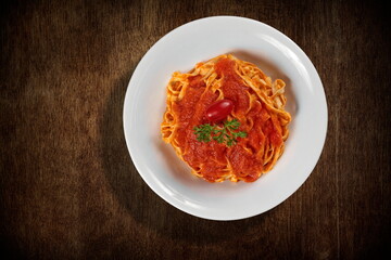 Fettuccine al Sugo, classic Italian pasta with tomato sauce seen from above on the plate