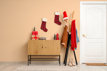 Interior of hallway with Christmas socks, drawers and coat rack