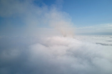 Aerial view from high altitude of earth covered with puffy rainy clouds forming before rainstorm