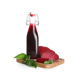 Bottle of fresh beet juice with basil on white background