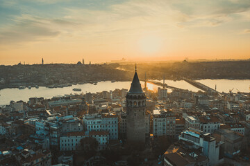 Obraz premium Galata Tower. Aerial view of Galata Tower at sunset. Golden Horn Metro Bridge are in the background. A unique view of Istanbul.