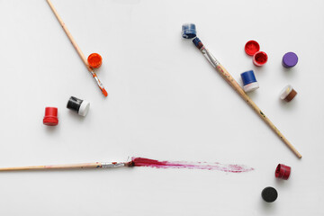 Artist brushes with paint stroke on white background