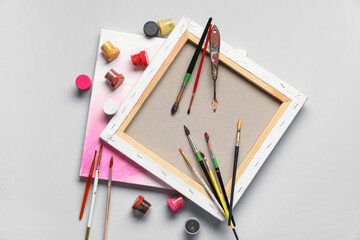 Artist brushes, canvas and paints on white background