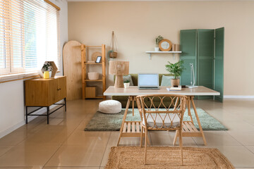 Interior of living room with programmer's desk, sofa and shelf unit