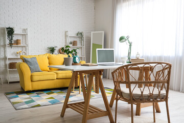 Interior of living room with programmer's desk, sofa and shelf units