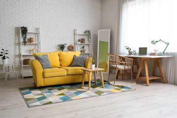 Interior of living room with programmer's desk, sofa and shelf units