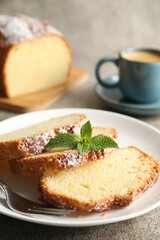 Freshly baked sponge cake and coffee on light grey table, closeup
