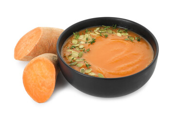 Delicious sweet potato soup with pumpkin seeds in bowl and fresh vegetable isolated on white