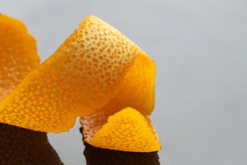 Fresh orange peel on dark table, closeup