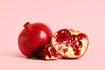 Fresh ripe pomegranates on pink background