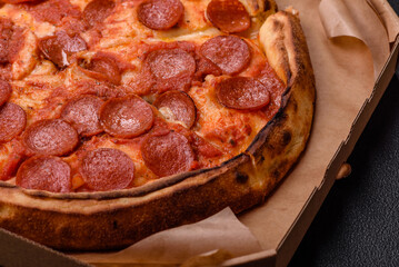 Pepperoni pizza with sausage, mozzarella cheese, tomatoes, salt and spices