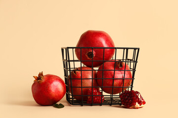 Basket with fresh ripe pomegranates on yellow background